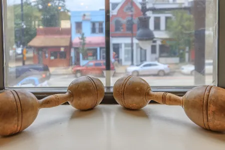 Wooden hand weights on the studio window sill