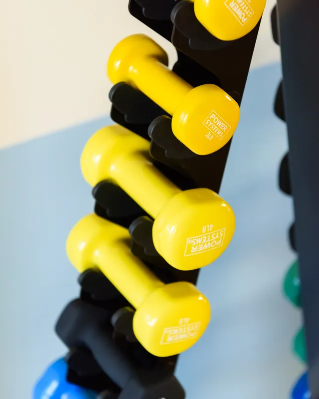 Hand weights on the studio rack