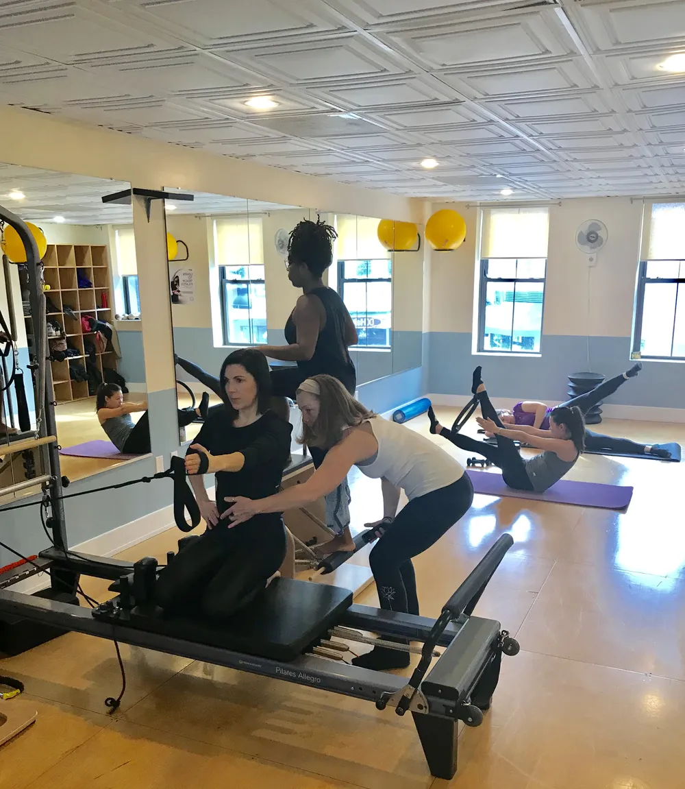 Inside the DC Pilates studio: reformers in use during a small group class